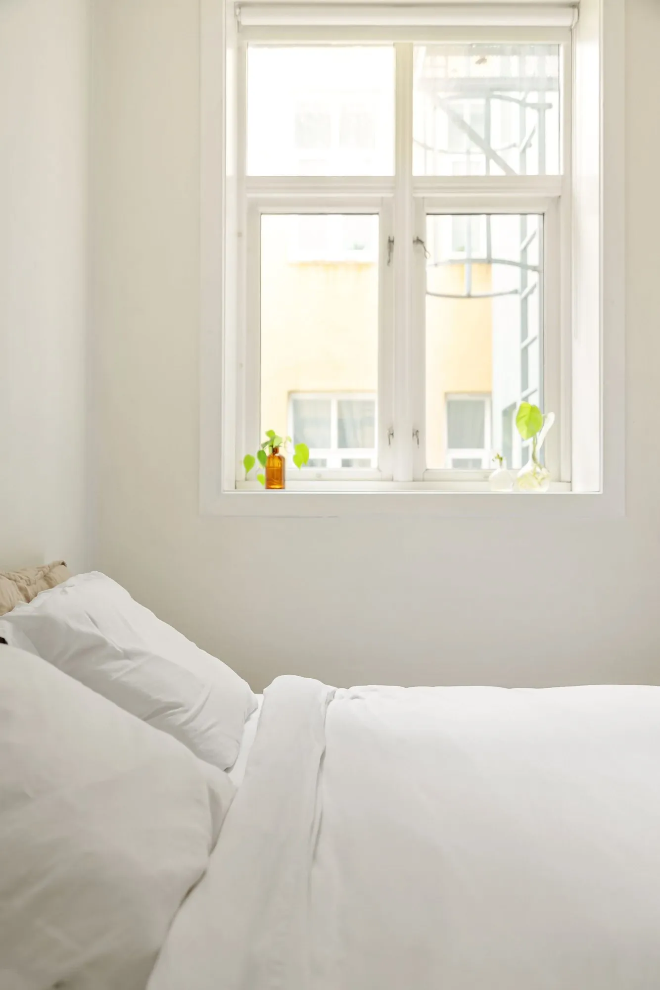 A Harbour Double with white bedding under a sash window onto the village